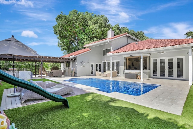 exterior space with ceiling fan, french doors, a patio area, and a yard