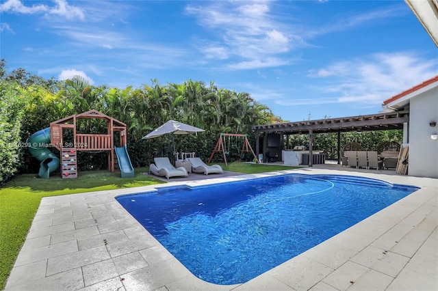 view of swimming pool with a playground, a patio area, a pergola, and a yard