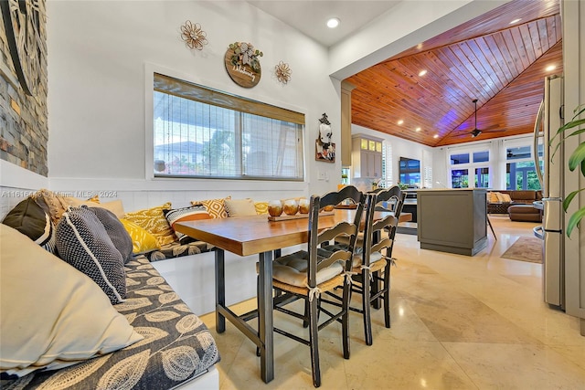 dining space featuring breakfast area, high vaulted ceiling, and wood ceiling