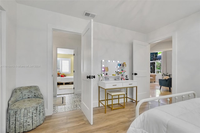 bedroom with light wood-type flooring and multiple windows