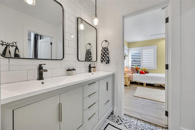 bathroom with vanity and tasteful backsplash