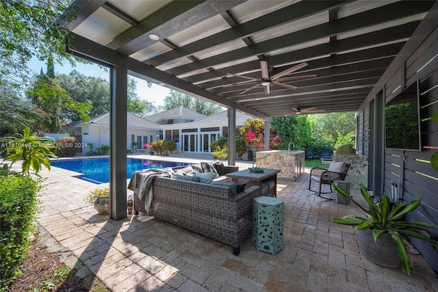 view of patio / terrace featuring an outdoor living space, an outdoor kitchen, and ceiling fan