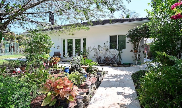 rear view of house featuring french doors