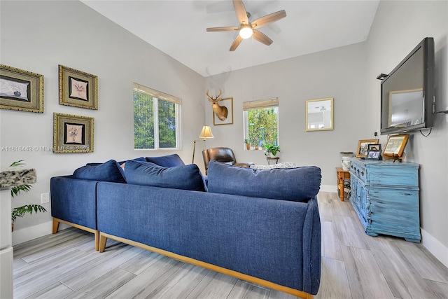 living room with light hardwood / wood-style flooring, plenty of natural light, and ceiling fan