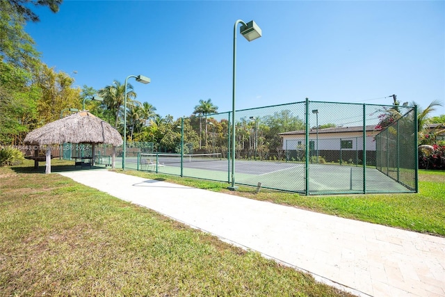 view of tennis court featuring a gazebo and a yard