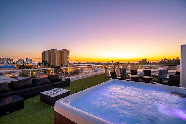 patio terrace at dusk featuring an outdoor hangout area