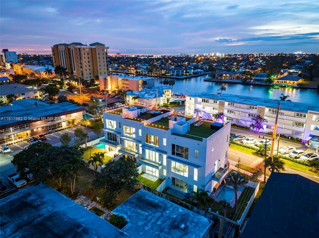 aerial view at dusk with a water view