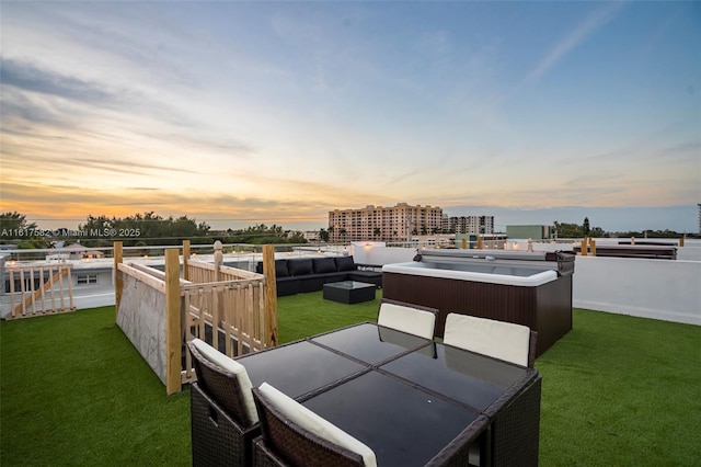 exterior space with an outdoor hot tub, a yard, and outdoor lounge area