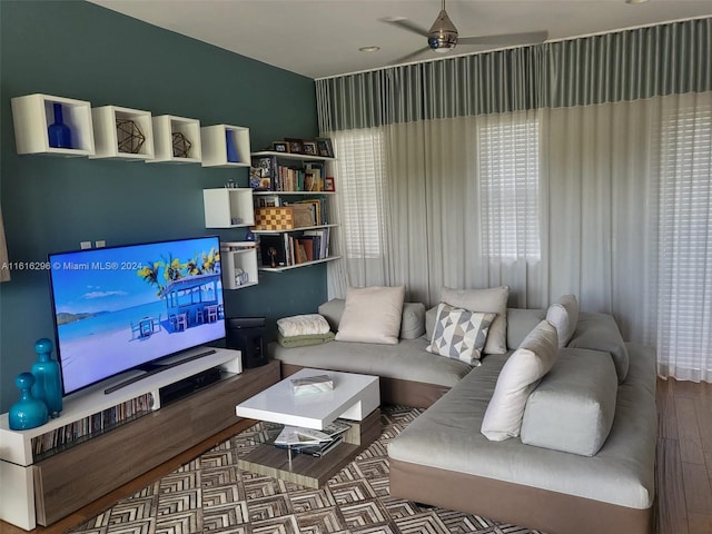 living area with wood finished floors and a ceiling fan