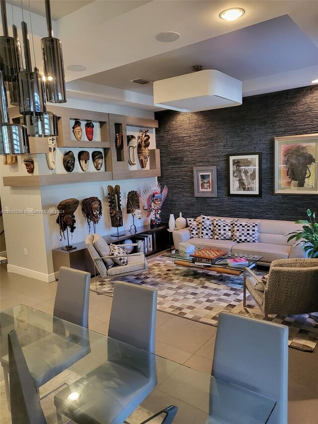 living room featuring tile patterned flooring and a tray ceiling