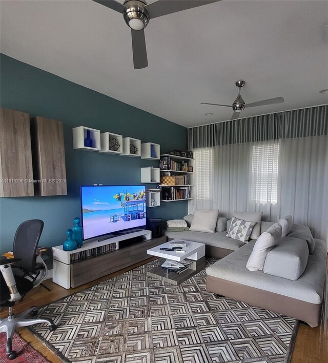 living room with ceiling fan and wood finished floors