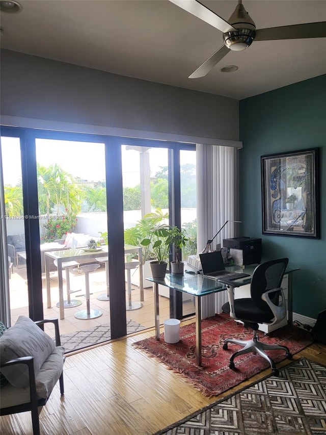 home office with hardwood / wood-style flooring and ceiling fan