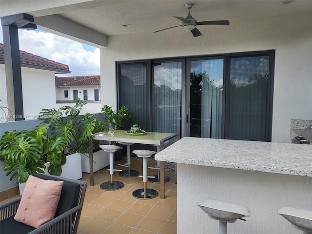 balcony featuring a patio, outdoor dining space, and a ceiling fan