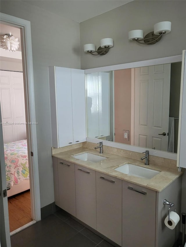 full bathroom with tile patterned floors, a sink, ensuite bath, and double vanity