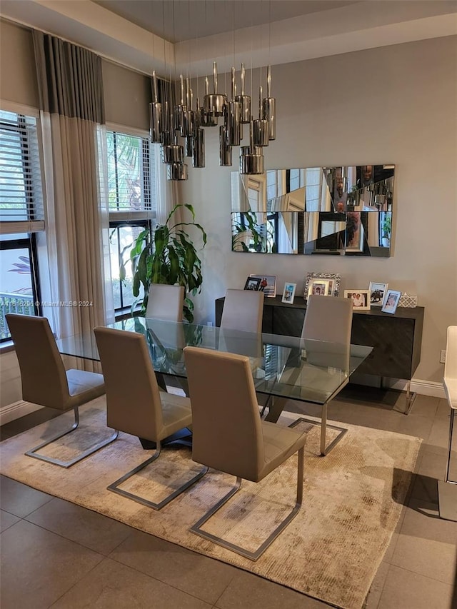 dining room featuring a notable chandelier and tile patterned floors