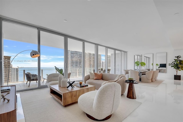 living room with a wall of windows and a water view