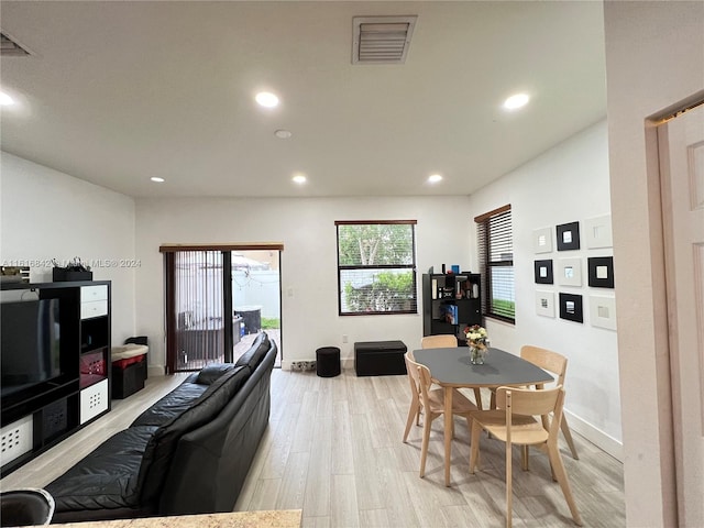 dining space with light hardwood / wood-style flooring