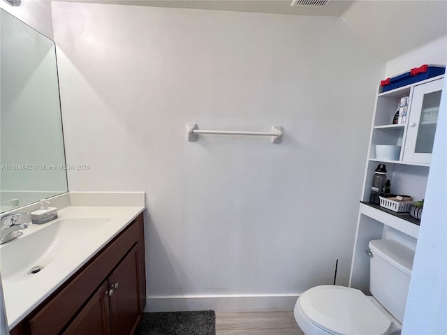 bathroom featuring hardwood / wood-style floors, vanity, and toilet