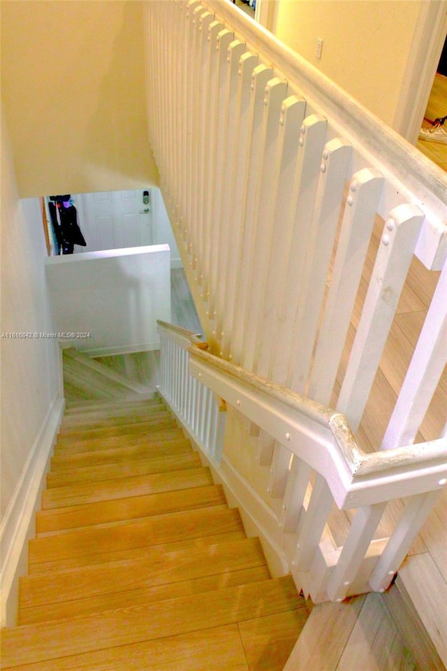 staircase featuring hardwood / wood-style flooring