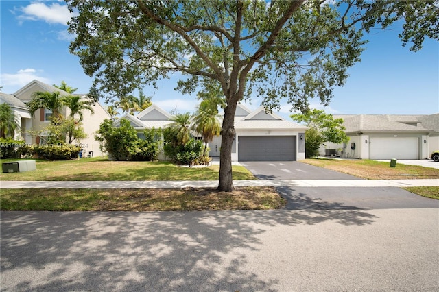 view of front of house featuring a garage and a front yard