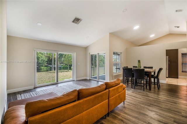 living room with wood-type flooring and vaulted ceiling