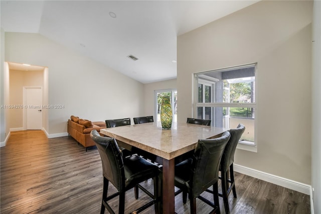 dining room featuring dark hardwood / wood-style flooring and lofted ceiling