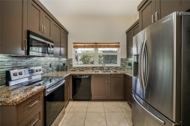 kitchen featuring appliances with stainless steel finishes, light tile patterned flooring, decorative backsplash, and sink