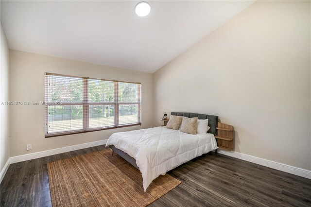 bedroom featuring dark hardwood / wood-style floors and vaulted ceiling