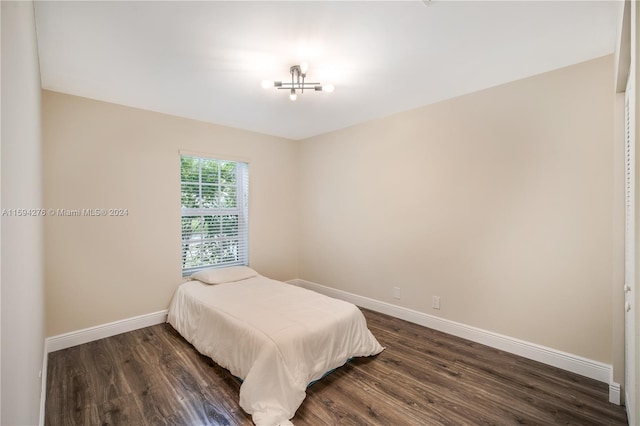 bedroom with dark hardwood / wood-style floors