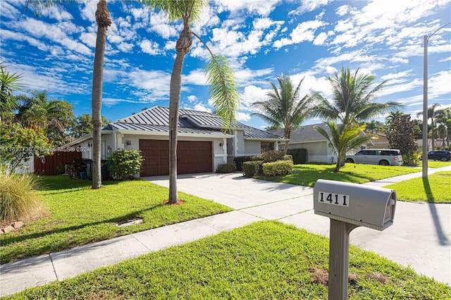 ranch-style home featuring a garage and a front lawn