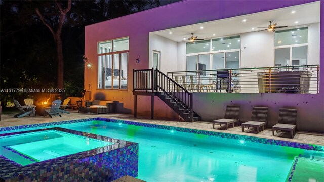 view of swimming pool with an in ground hot tub, an outdoor fire pit, a patio, and ceiling fan