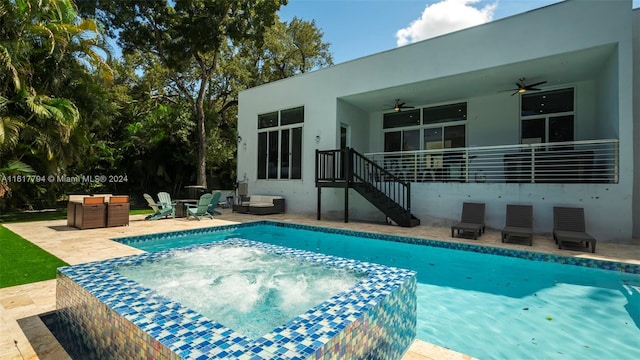 view of pool featuring a patio area, a hot tub, and ceiling fan