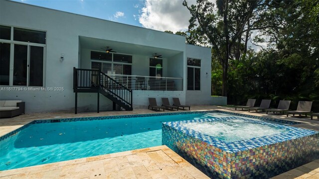 view of swimming pool with ceiling fan and a patio