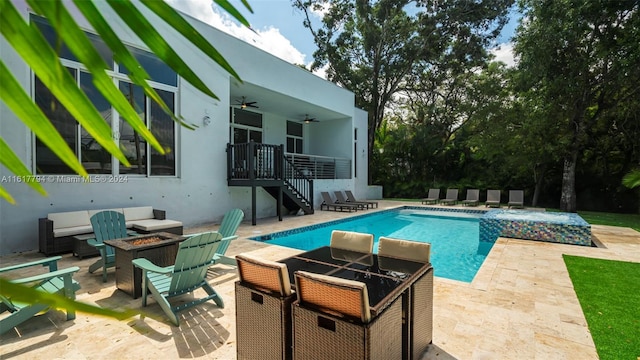 view of pool featuring an outdoor fire pit, a patio area, and ceiling fan