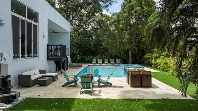 view of swimming pool with ceiling fan, a patio area, a yard, and an outdoor hangout area