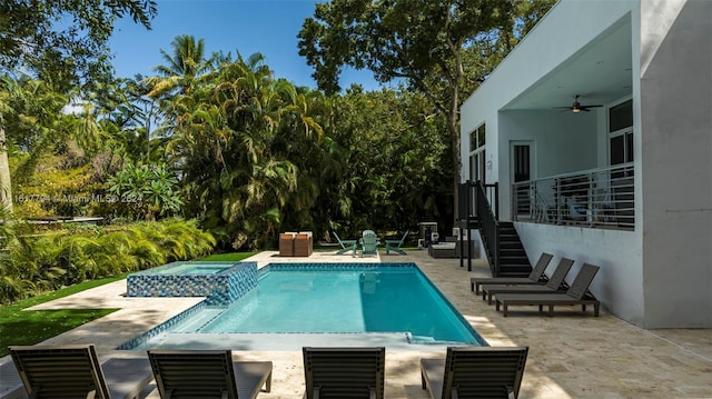 view of pool featuring an in ground hot tub, a patio, and ceiling fan