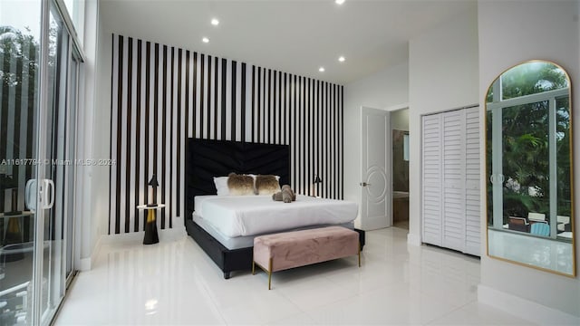 bedroom featuring a towering ceiling and light tile patterned floors