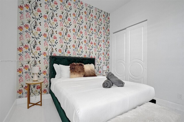 bedroom with a closet and tile patterned floors