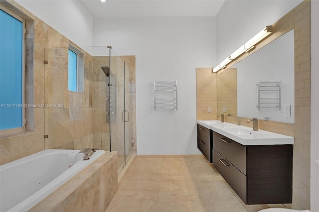 bathroom featuring radiator heating unit, plus walk in shower, tile patterned floors, and vanity