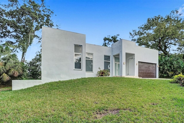 contemporary home with a garage and a front lawn