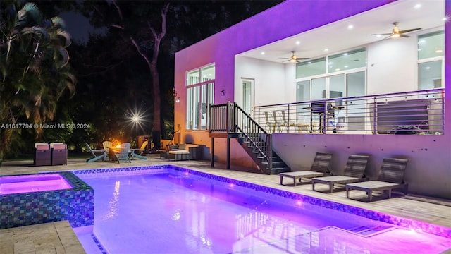 view of swimming pool with a fire pit, an in ground hot tub, a patio, and ceiling fan