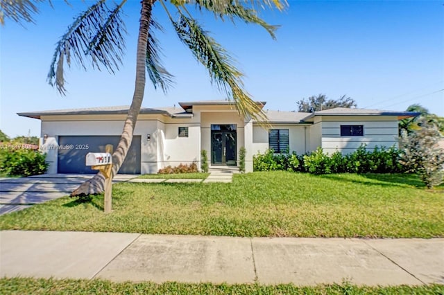 view of front of house with a garage and a front lawn