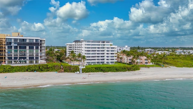 drone / aerial view with a beach view and a water view