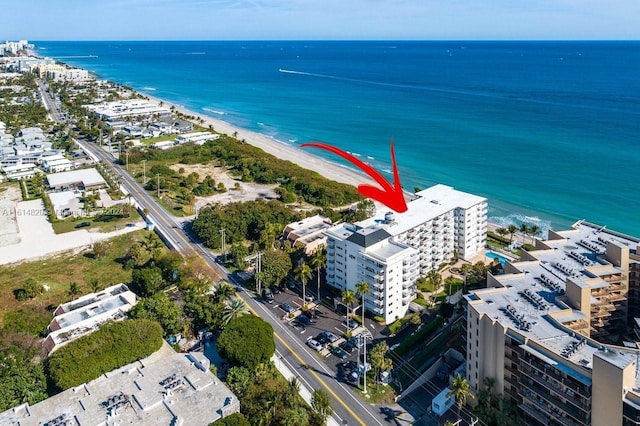 birds eye view of property with a view of the beach and a water view