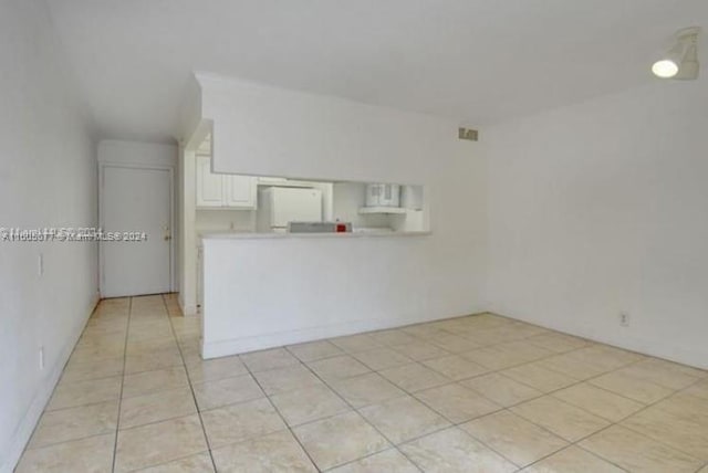 unfurnished living room featuring light tile patterned flooring