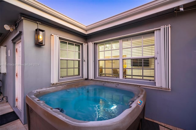 exterior space with tile patterned flooring and a hot tub