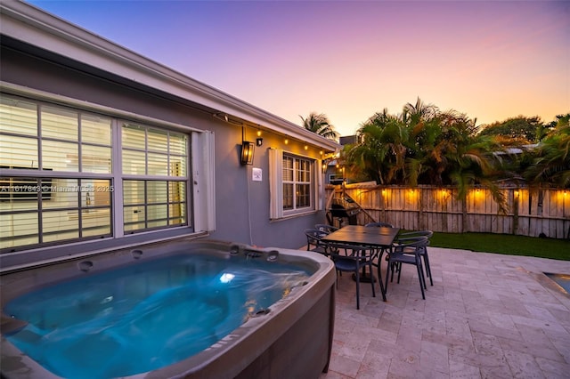 patio terrace at dusk with a hot tub