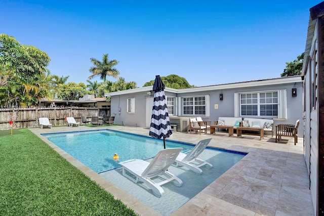 view of swimming pool with a patio, a lawn, and outdoor lounge area