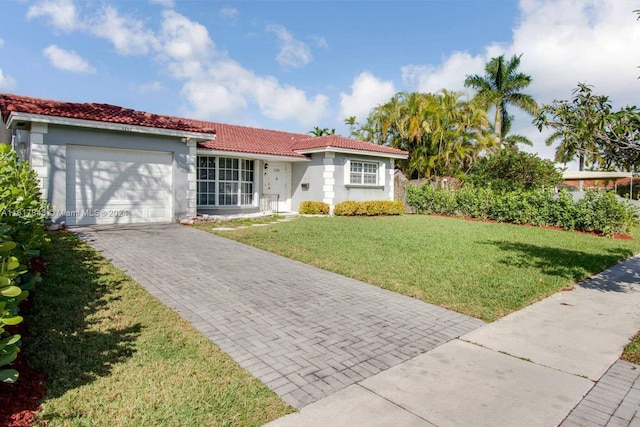 view of front of property featuring a garage and a front yard