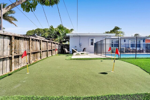 view of yard with a fenced in pool, a lanai, and a patio area